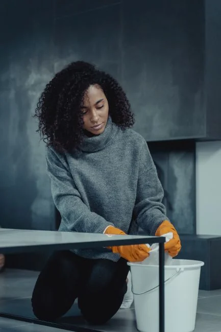 A contemporary cleaning tool designed to wipe a large glass window overlooking a clear outdoor scene.
